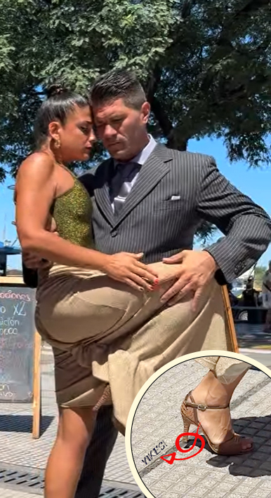 Couple dancing tango on cobblestones